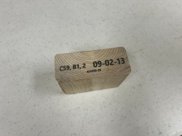 A piece of lumber with a label printed on it by the Woodchuck Lumber Parts Saw